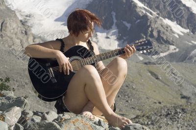 Girl playing guitar in the mountains 03
