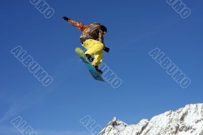 Snowboarder jumping high in the air