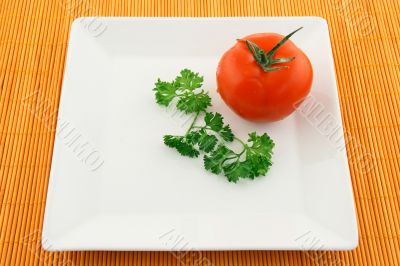 Tomato and parsley on a square plate