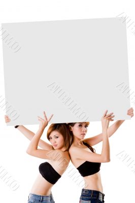 two girls with a big sign