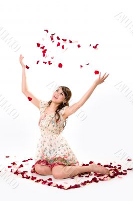 young girl tossing rose petal