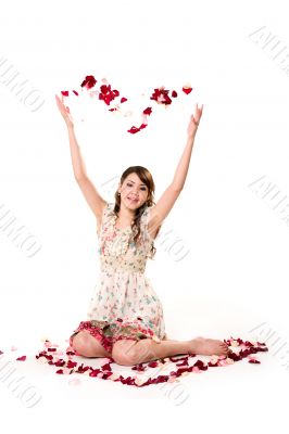 young girl tossing rose petal