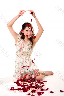 young girl tossing rose petal
