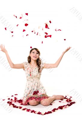 young girl tossing rose petal