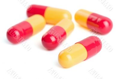 red and yellow capsule pills isolated