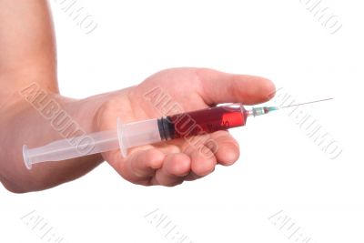 Hand with a syringe