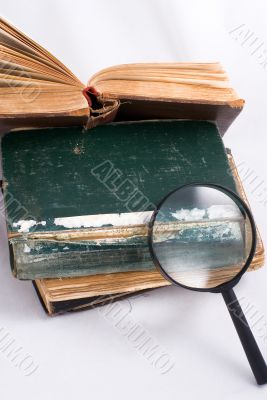 Old books and magnifier