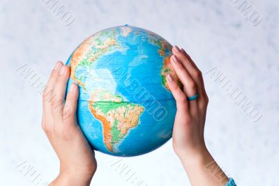 Hands hold the globe