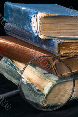 Old books and magnifier