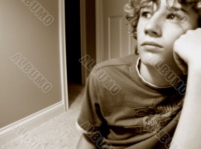 depressed boy in front of doorway to unknown