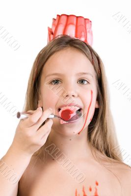 Blond child with desert on her head eating