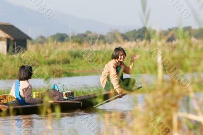 two young girls in wooden canoe