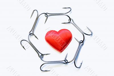 The red heart surrounded with a chain of hooks