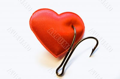 The red heart pinned on a fishing hook