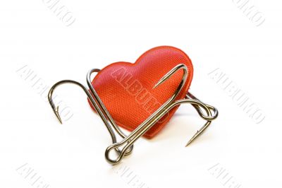 Red heart with a fishing hook on a white background