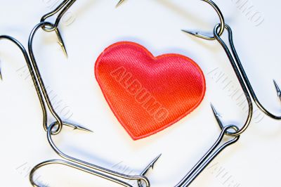 The red heart surrounded with a chain of hooks
