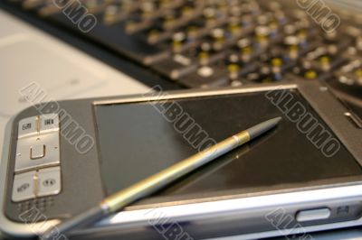 porket computer and notebook on table