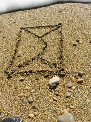 envelope on wet sea sand