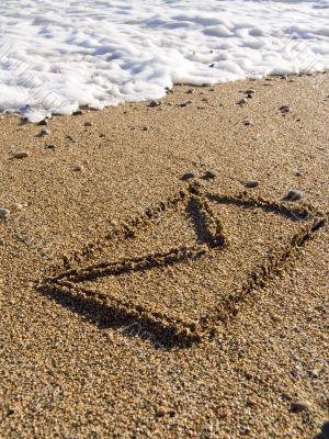 envelope on wet sea sand