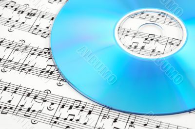 Blue CD or DVD on sheet music