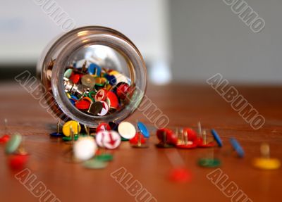 thumbtacks in a glass