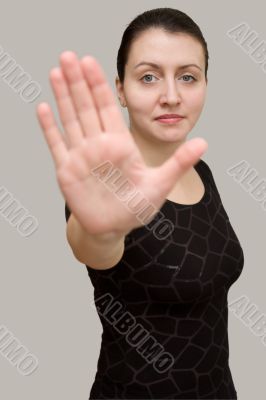 Stop. woman on a grey background.