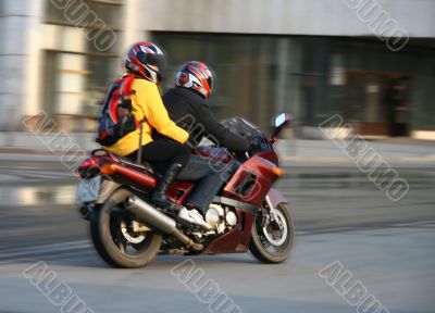 Pair on a motorcycle.