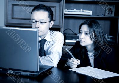 business partners on a laptop in an office