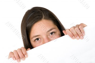 girl peeping over a white card