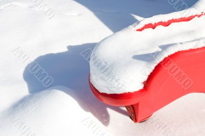 Red Plastic Slide in Snow
