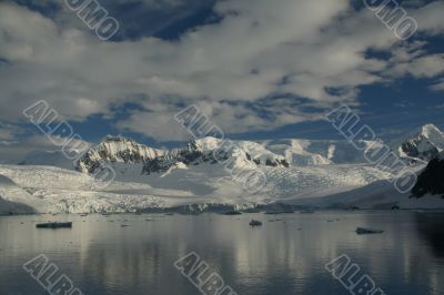 Reflections of glacial icefalls and mountains