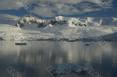 Reflections of glacial icefalls and mountains