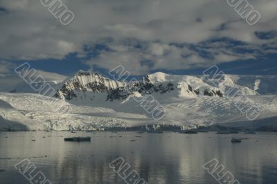 Reflections of glacial icefalls and mountains