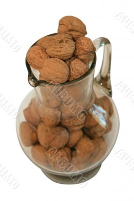 Handful of walnuts in a glass decante