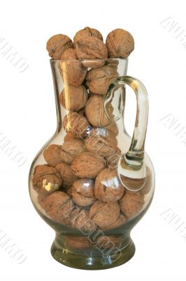 Handful of walnuts in a glass decante