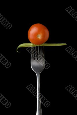 Cherry tomato and peas on fork