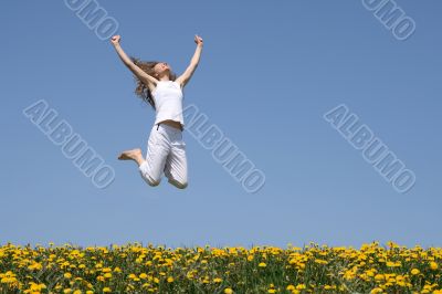 Smiling young woman in a happy jump
