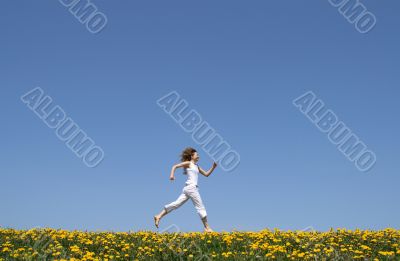 Happy girl running in dandelion field