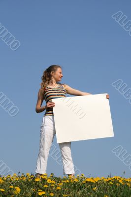 Young woman holding blank cardboard with copyspace