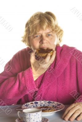 Senior woman is having breakfast