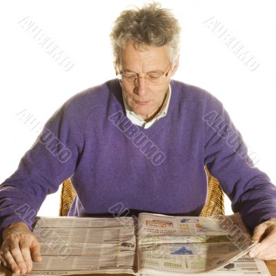 Elderly man is reading newspapers
