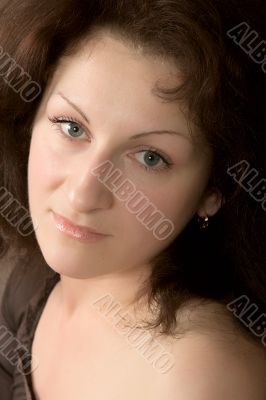 Portrait of the young woman on a dark background.