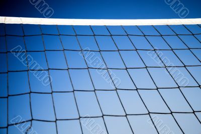 beach volleyball net with a blue sky