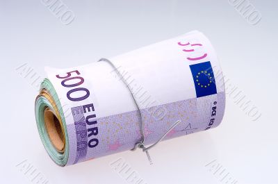 Roll of euros close-up on gray background.