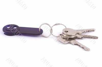 Bunch of keys with dark blue smile trinket.