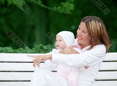 happy mother with baby on the bench