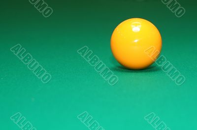 shot of pool table and yellow ball