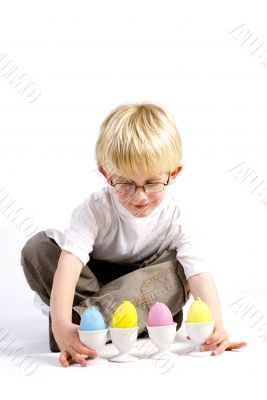 Little boy plays with easter eggs
