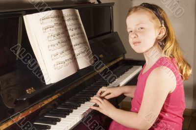 little girl playing the piano