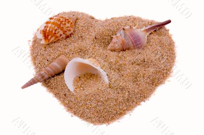 Heart from sand with cockleshells on white.